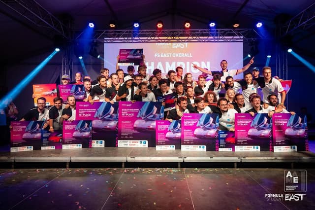 🇭🇺 Formula Student East 2024 🇭🇺<br /><br />We are overall EV & DV champions at FSEast 2024 🏆 🏎️<br /><br />During the first week of august, we attended our third event of the 2024 season, Formula Student East, at the ZalaZone Automotive Proving Ground in Zalaegerszeg, Hungary.<br /><br />This event was also the first event with a driverless (DV) category alongside the manual (EV) category for us this season. This meant that we had a lot more disciplines packed into the week, as we competed in both categories simultaneously with the same car and team.<br /><br />The event began with technical inspections, where we swiftly passed scrutineering and made the finals in EV and DV Design, as well as Cost, winning all three and securing overall statics victories in EV and DV. In dynamics, we achieved top positions in manual and driverless disciplines, including 2nd in manual Autocross and 1st in Endurance, despite challenging conditions. Our performance culminated in overall victories in both EV and DV categories, marking the first time a car has won both since the EV/DV merge. We are immensely proud of this unprecedented achievement.<br /><br />At this point, we would like to thank the organizers at @formulastudenteast for organizing an event we won’t forget for a while. Thanks also to all other teams for the great competition. Special congratulations to @arrabona_racing_team for the overall win in the combustion class, and to @tugracing for yet another skidpad record!<br /><br />Results FSEast 2024:<br /><br /> Electric category:<br /><br />🏆 Overall<br />🏆 Dynamics overall<br />🏆 Statics overall<br />🥇 Endurance<br />🥇 Engineering Design<br />🥇 Cost & Manufacturing <br />🥈 Autocross<br />🥉Skidpad<br />4th place Efficiency<br />5th place Acceleration<br />9th place Business Plan Presentation<br /><br />Driverless category:<br /><br />🏆 Overall<br />🏆 Statics overall<br />🥉 Dynamics overall<br />🥇 Engineering Design<br />🥇 Cost & Manufacturing <br />🥉 Autocross<br />🥉 Acceleration<br />4th place Trackdrive<br />4th place Skidpad<br />6th place Business Plan Presentation<br /><br />Meanwhile, our last competition of the season is underway at the Hockenheimring. So stay tuned for updates regarding Formula Student Germany, where we are determined to deliver a great performance again to finish the season on a high!<br /><br />📸: FSEast